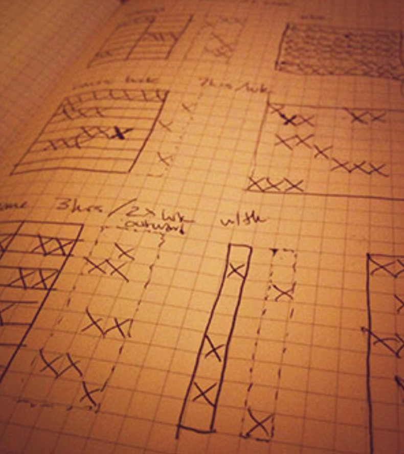 grid of X drawn out on a moleskine sketchbook